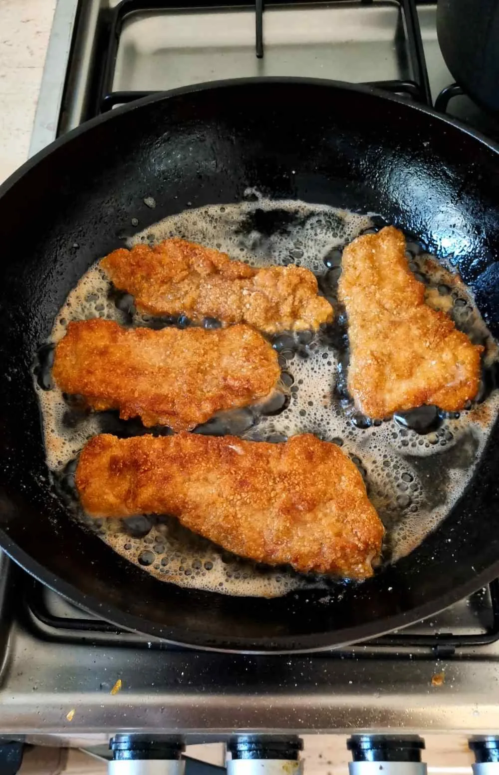 overcrowded pan frying breaded chicken